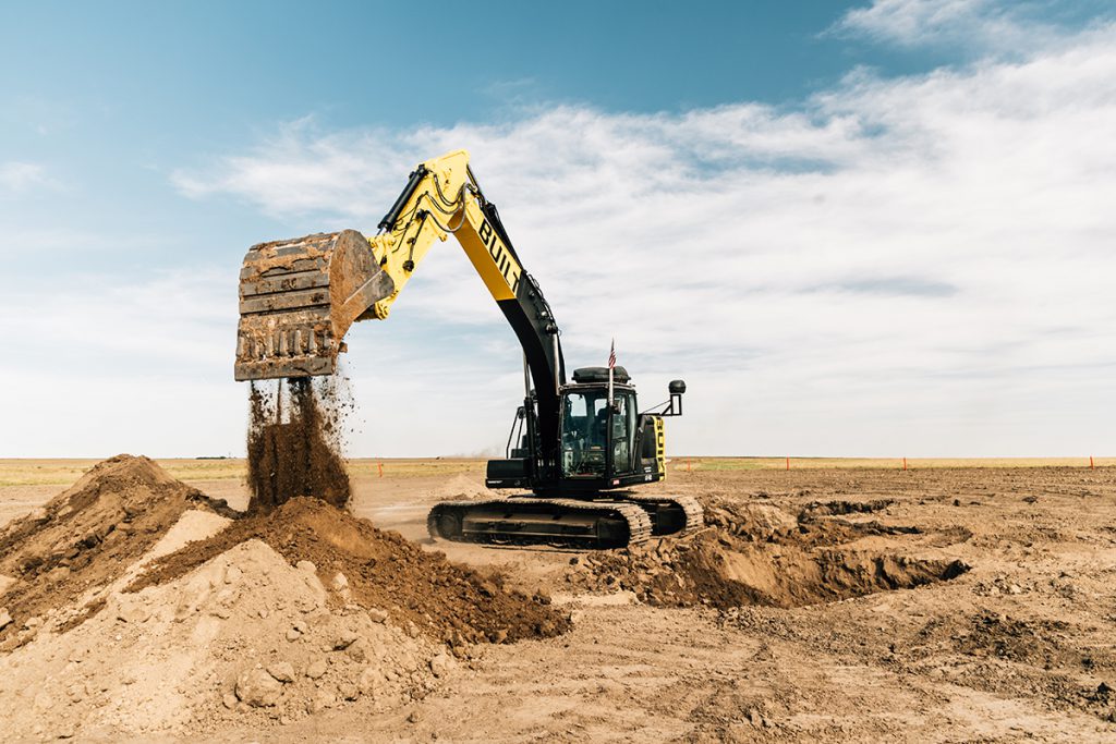automated robots construction machinery scooping dirt withblue sky