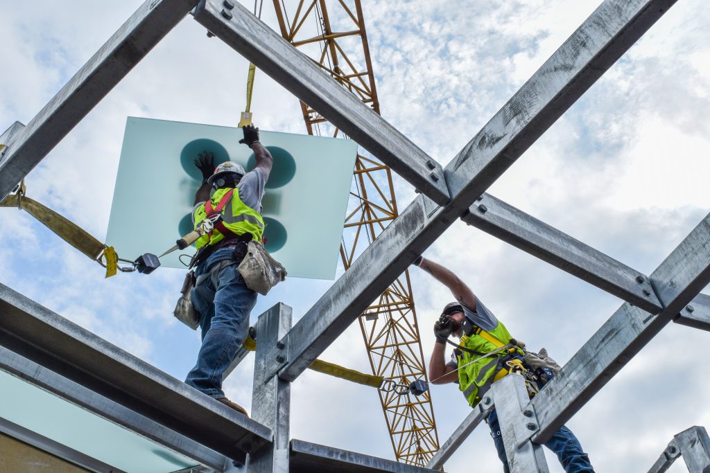 construction workers installing glass project