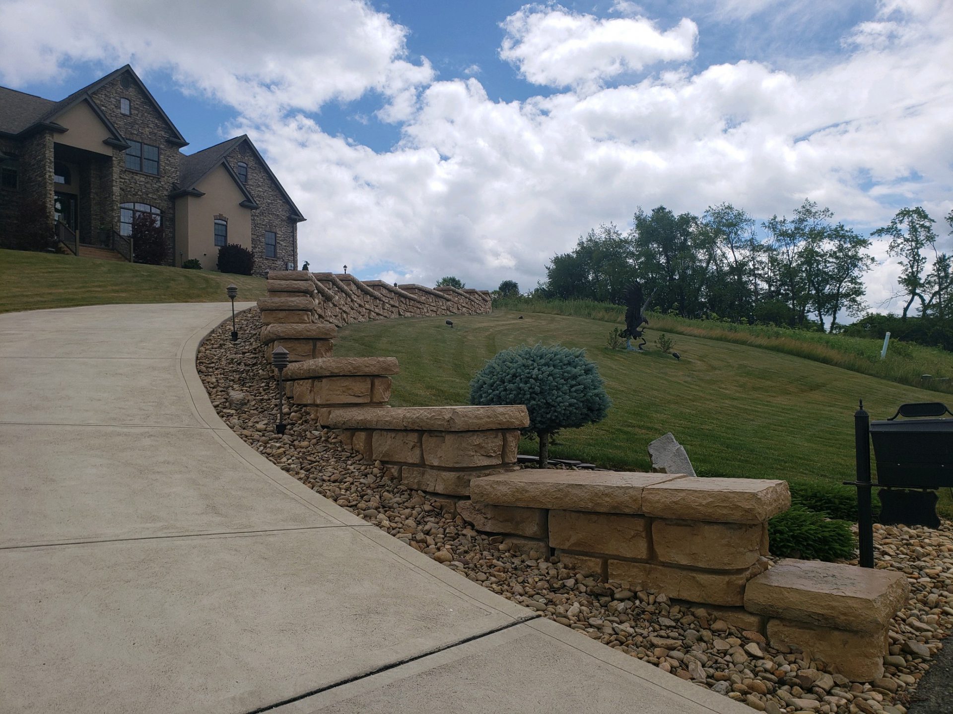 stone wall along walkway to house