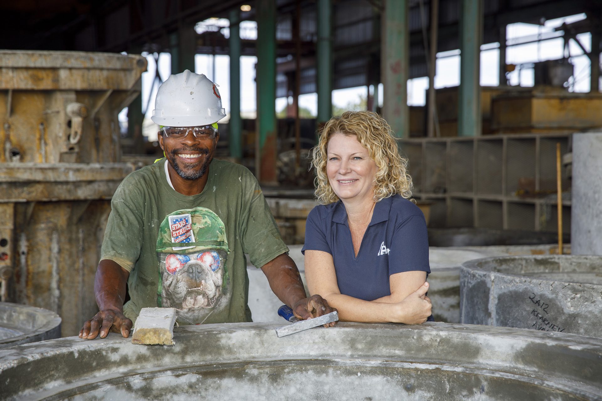 smiling workers on concrete construction site