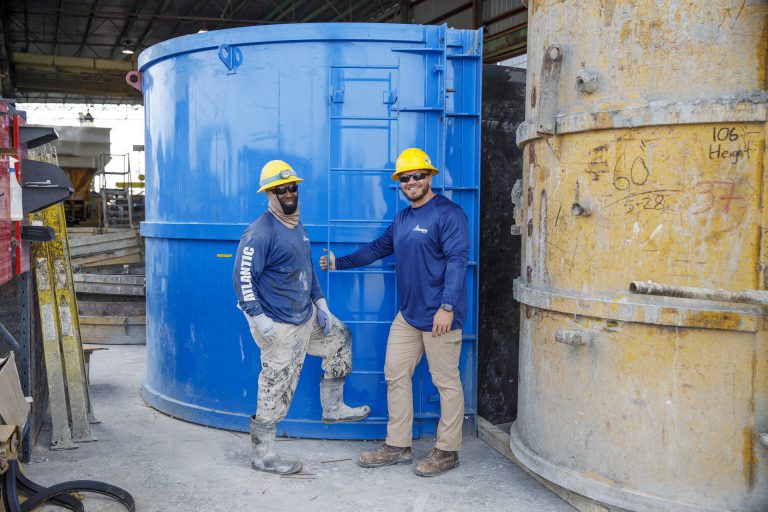 Smiling employees at Atlantic TNG standing on site