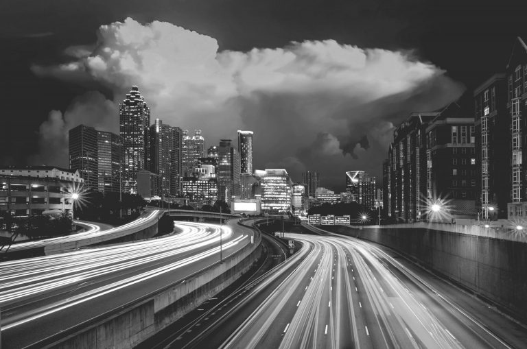 city ahead on a road at night