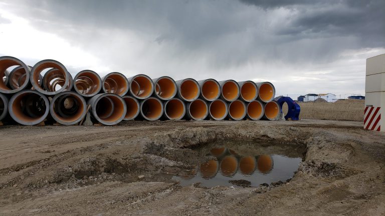 rows of stacked concrete pipes