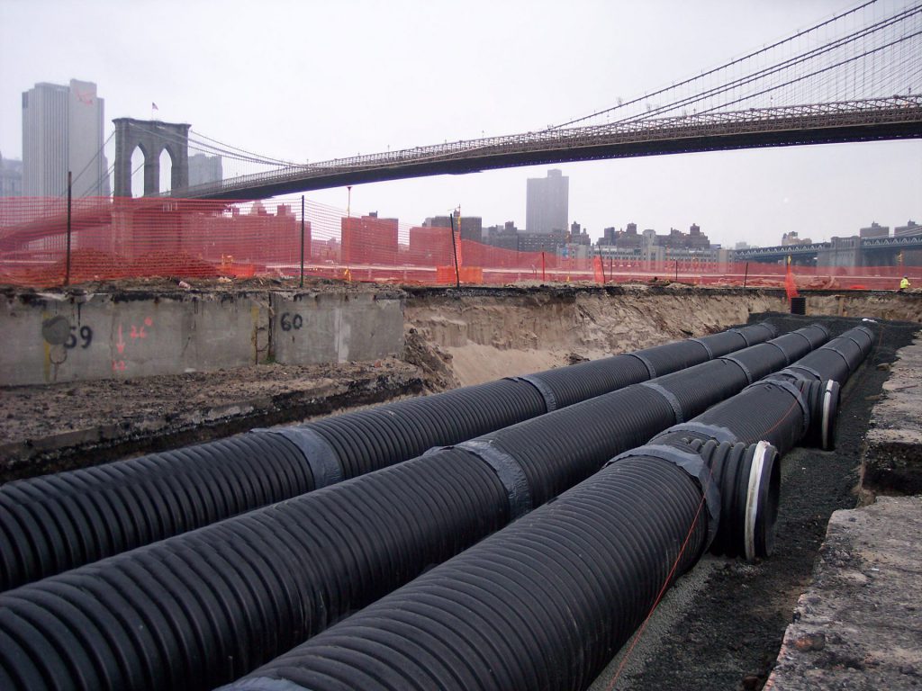 Plastic pipe with Brooklyn Bridge in background