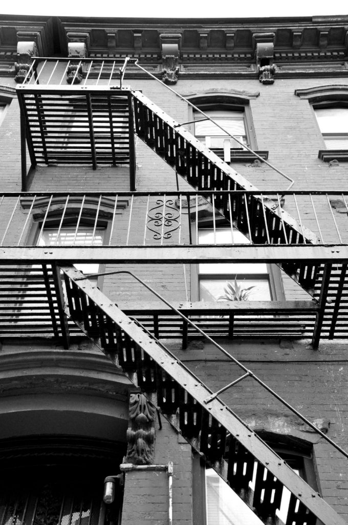 view looking upwards underneath staircases of affordable housing apartment building