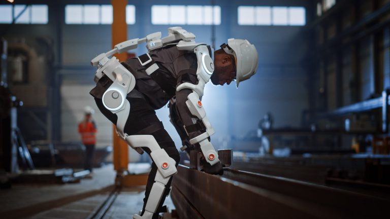 construction worker indoors wearing exoskeleton suit