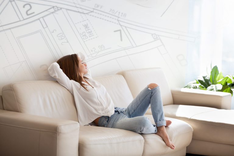 female relaxing on couch in bright home